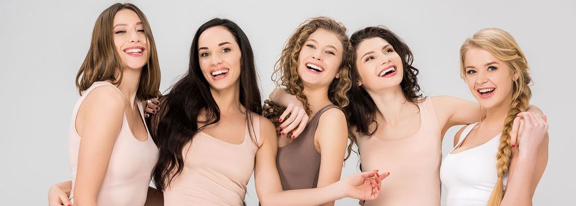 A group of women are posing for a picture together and smiling.