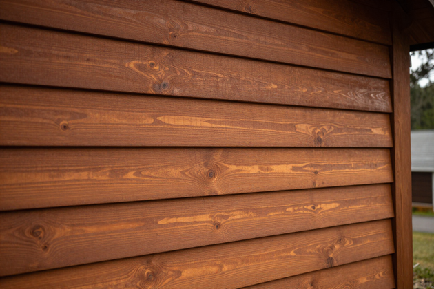 Rich warm-toned cedar horizontal siding on a Pacific Northwest craftsman-style home.