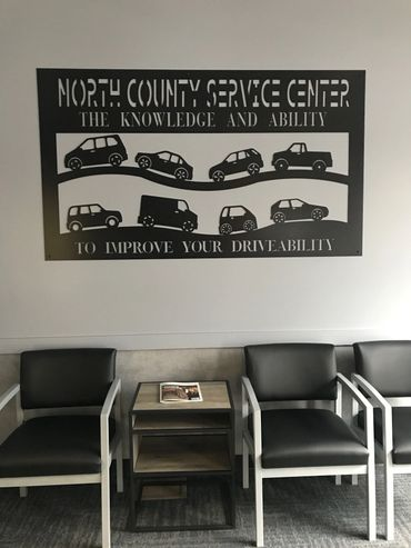 A waiting room with chairs and a sign that says north county service center. | North County Service Center