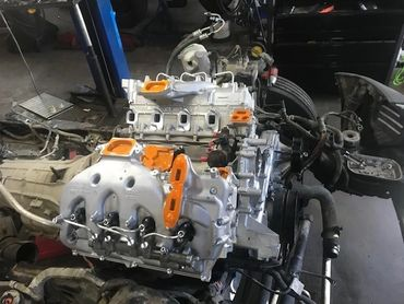 A car engine is being worked on in a garage | North County Service Center