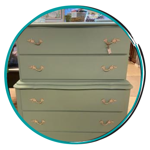 Mint-green dresser with four drawers and gold floral handles in a room