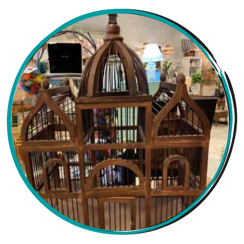 Wooden birdcage-shaped decorative display with a domed top in a shop setting