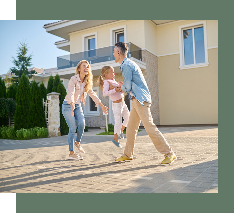 A family is playing in front of their new house.