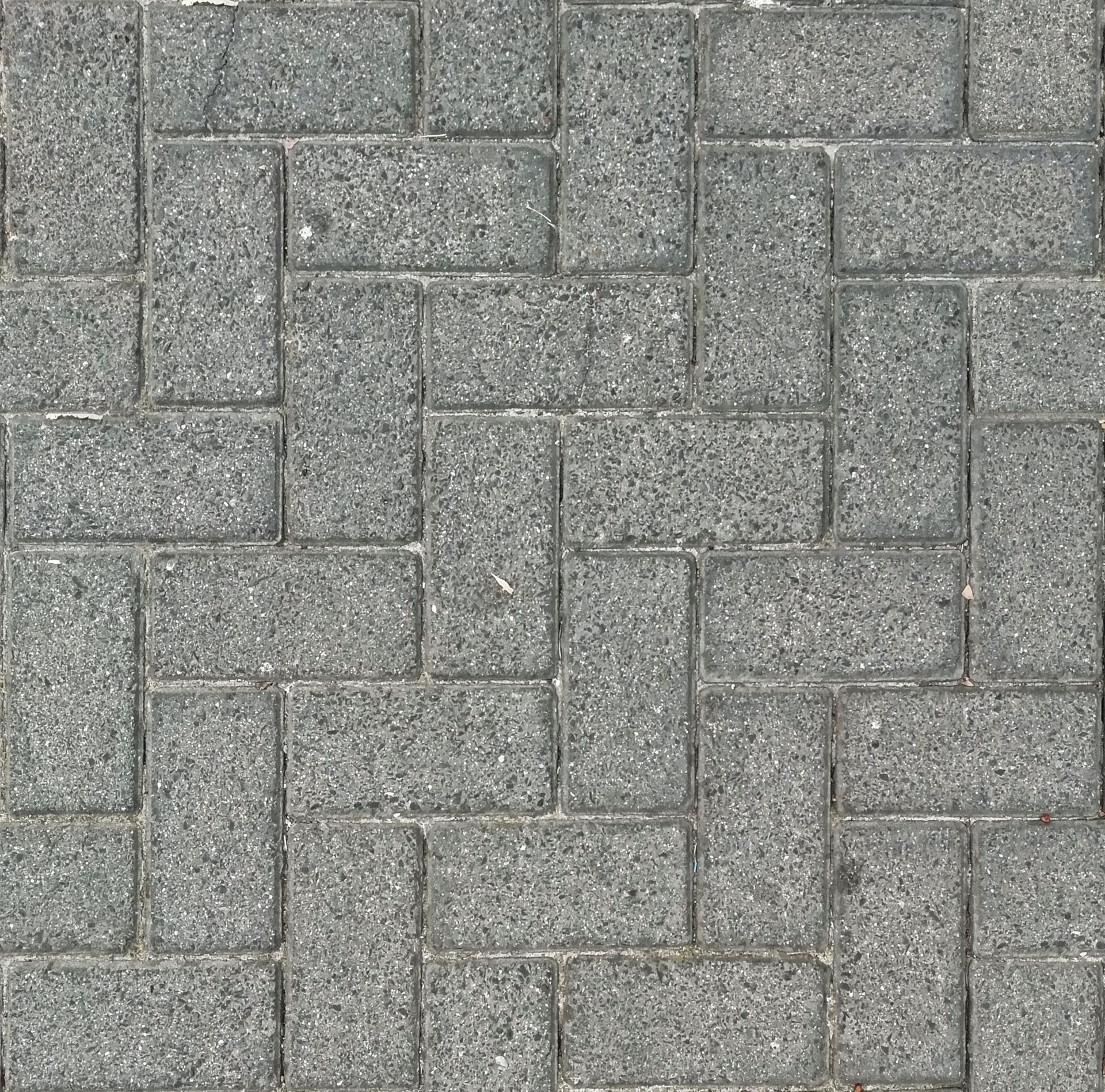 Gray interlocking brick pavers pattern with a slightly rough texture
