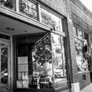 Storefront with glass entrance and brick exterior on a city street
