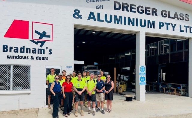 Staff in front of shop — Expert Glaziers in Bowen, QLD