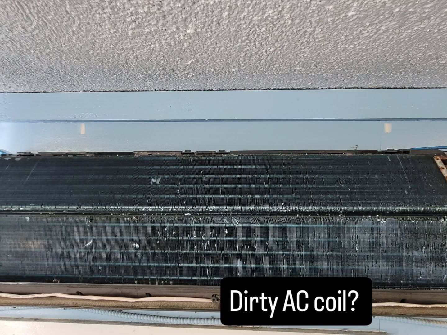 Dusty black AC coil with white debris buildup, labeled “Dirty AC coil?”