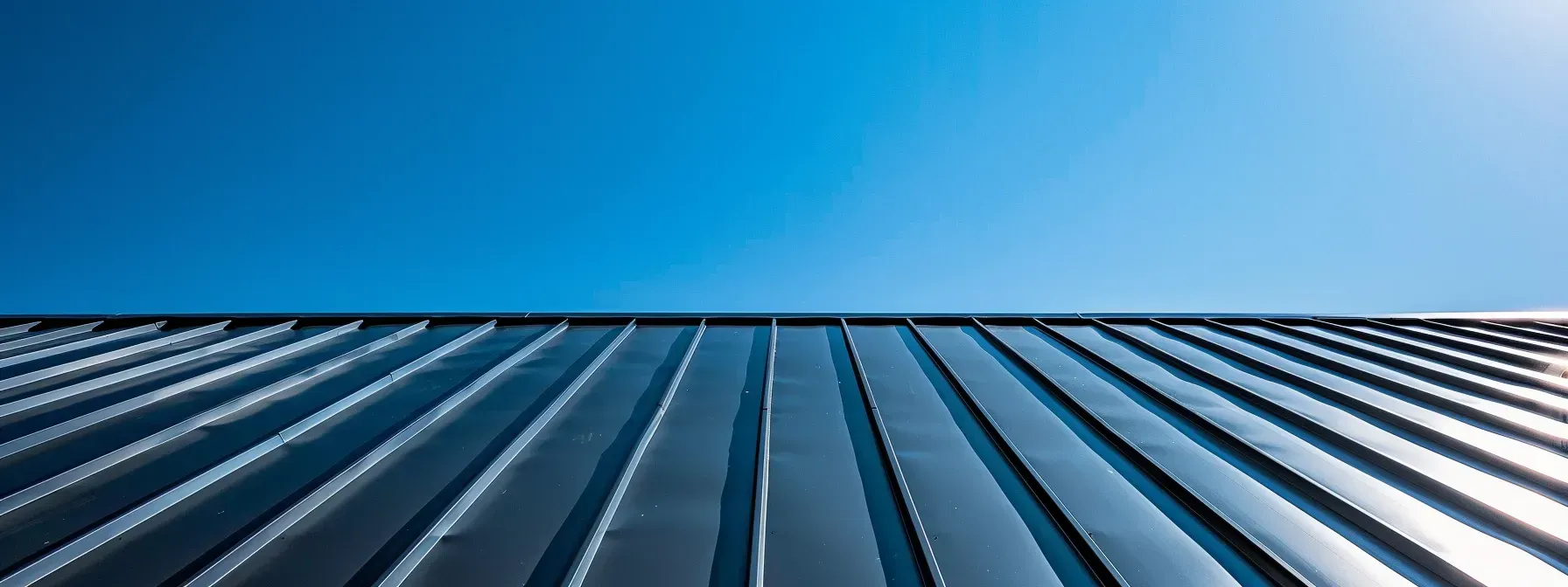 Looking up at a metal roof with a blue sky in the background.