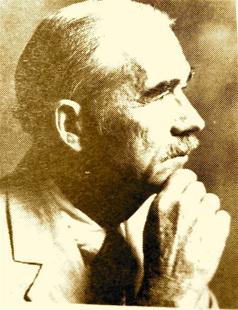 Sepia portrait of a man in profile, resting his chin on his hand and looking to the right.