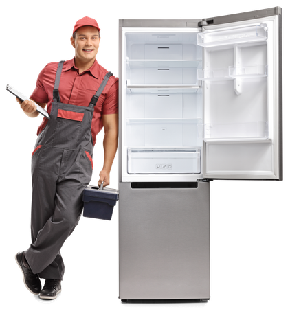 Refrigerator repairman in overalls and cap, standing by an open, empty stainless steel refrigerator.