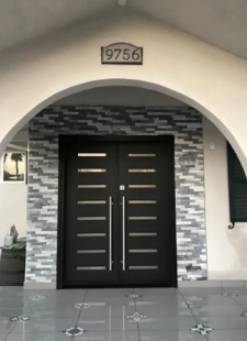 The front door of a house with the number 9756 on it