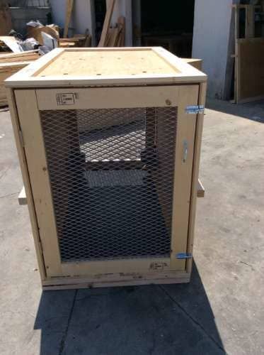 Wooden crate with wire mesh door.