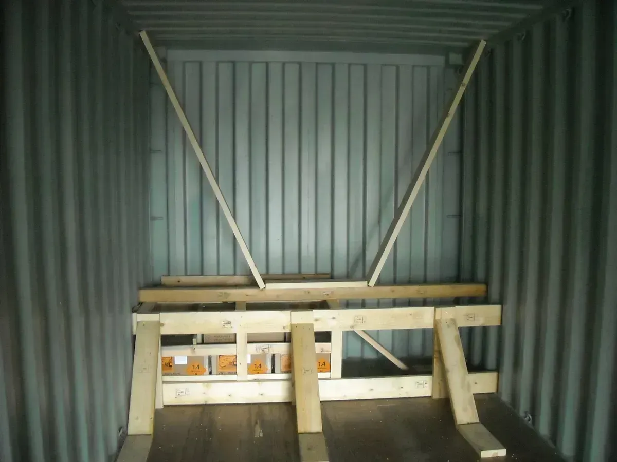 Wooden bracing inside a shipping container, likely to secure cargo during transport.