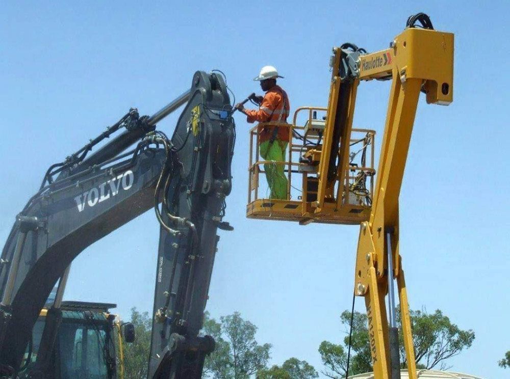 Volvo Excavator Is Being Worked On By A Man In A Bucket — Wetzler Pty Ltd In Marmor QLD