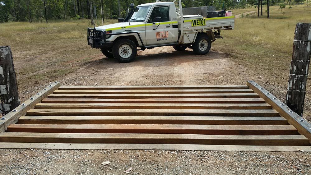 White Truck Is Parked On A Dirt Road Next To A Wooden Bridge — Wetzler Pty Ltd In Marmor QLD