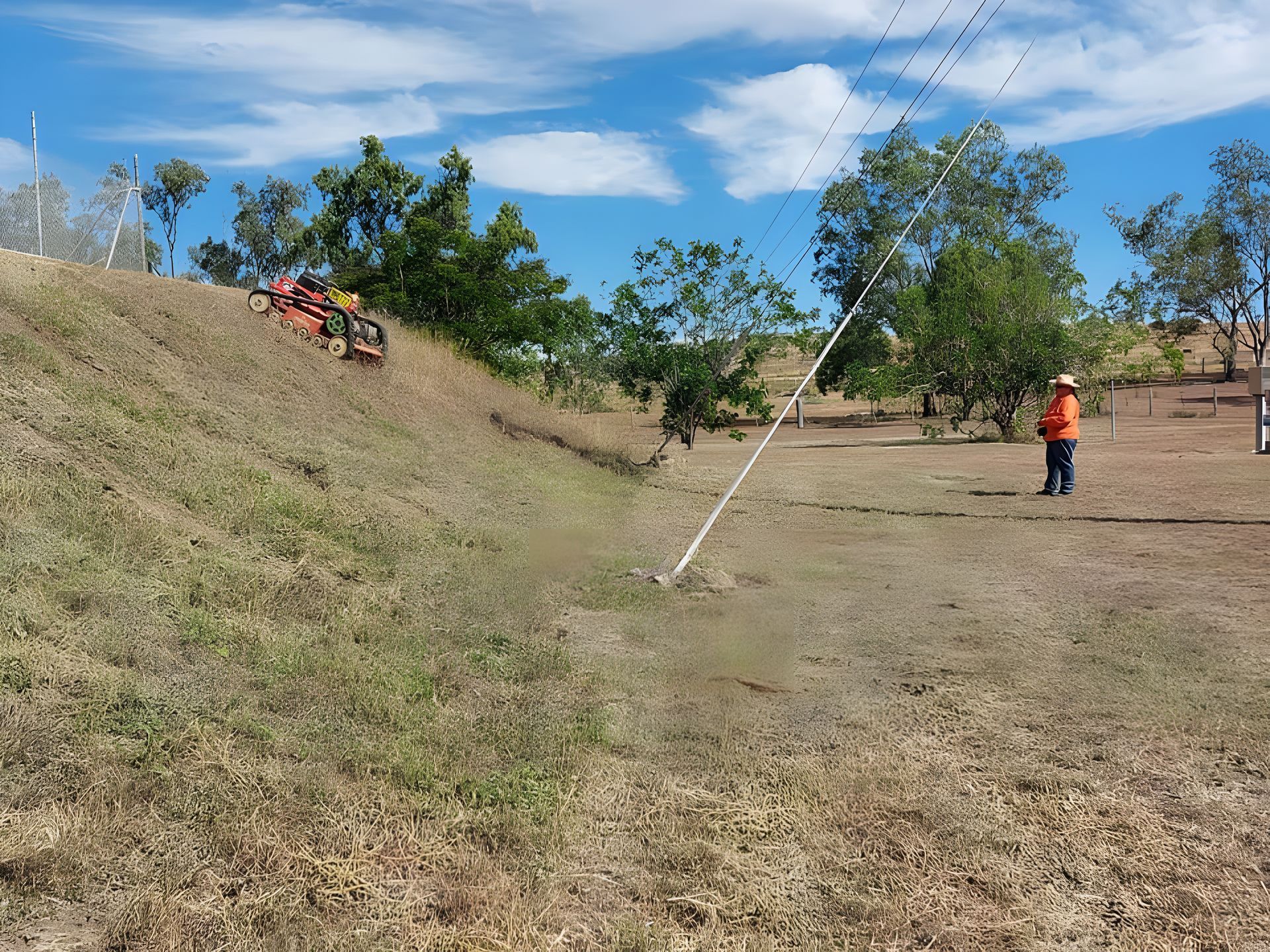 Worker Cutting the Grass using Remote Control Mower — Wetzler Pty Ltd In Marmor QLD