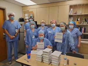 a group of people wearing blue scrubs and masks