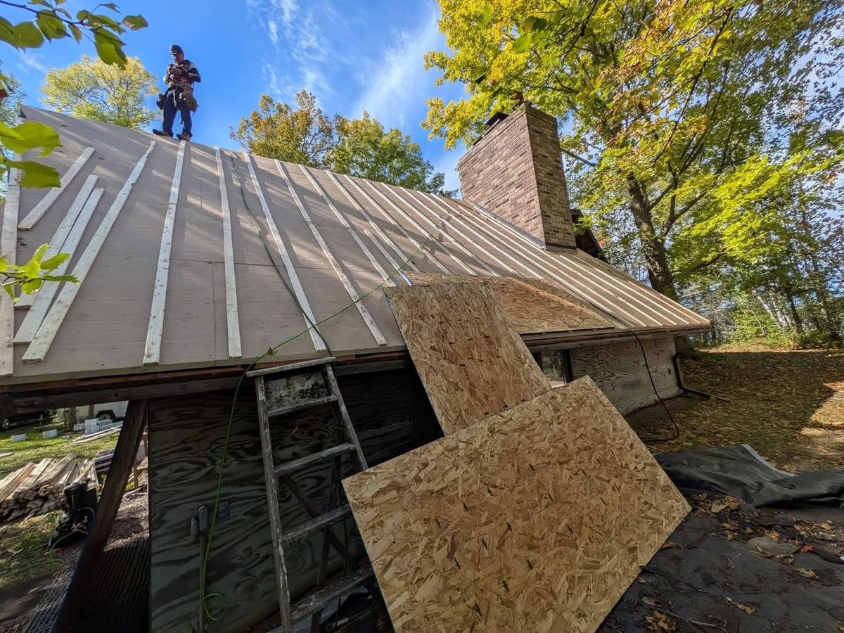 Archway Contracting team working on furring strips and ventilation preparation for a-frame roof.