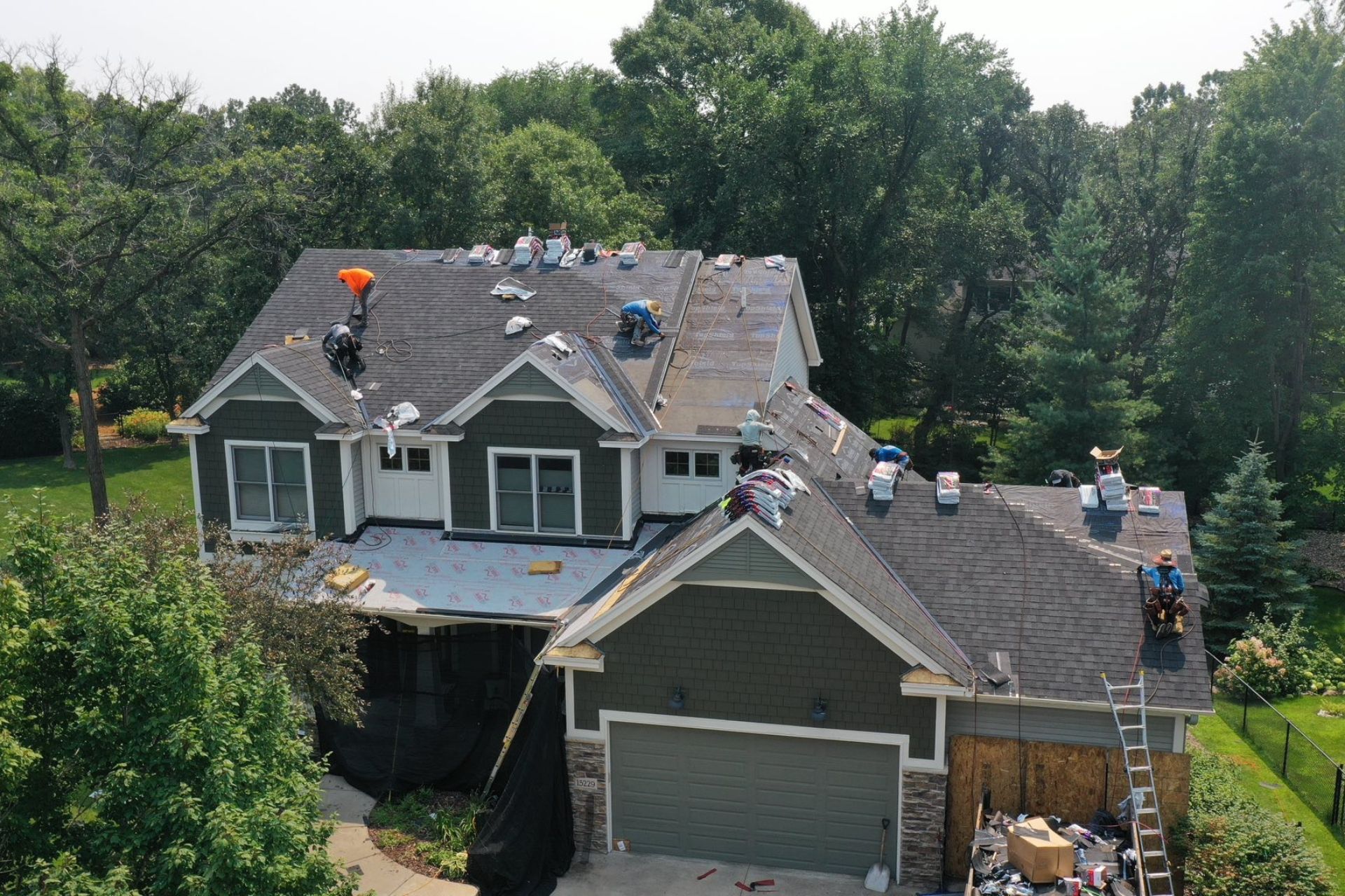 Minnesota homeowner comparing roof shingle colors and performance options with Archway Contracting