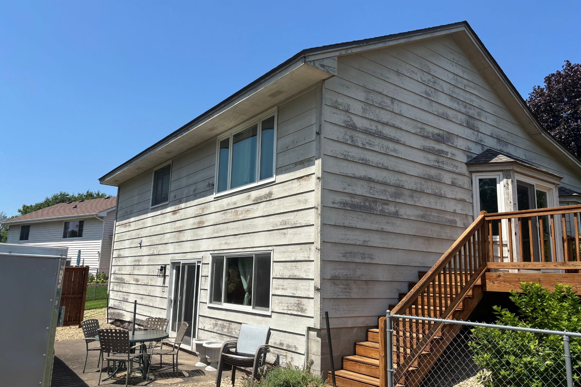 Weathered, cracked siding on a Minnesota home showing signs it may be time for replacement.