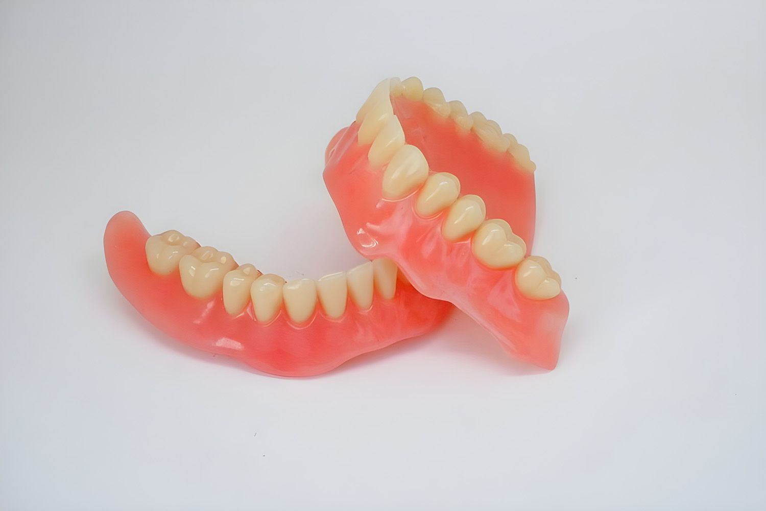 A Full Set Of Upper And Lower Dentures With Pink Gums And White Teeth
