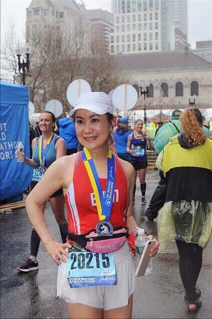 A woman wearing mickey mouse ears is running a marathon
