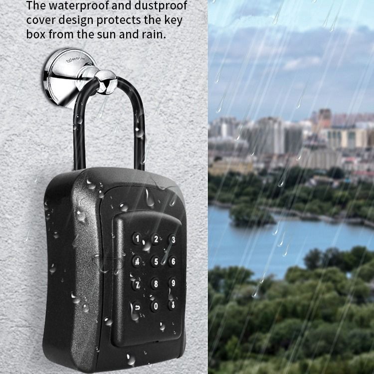Black weatherproof key safe mounted on a wall; background shows a rainy day with a cityscape and water.