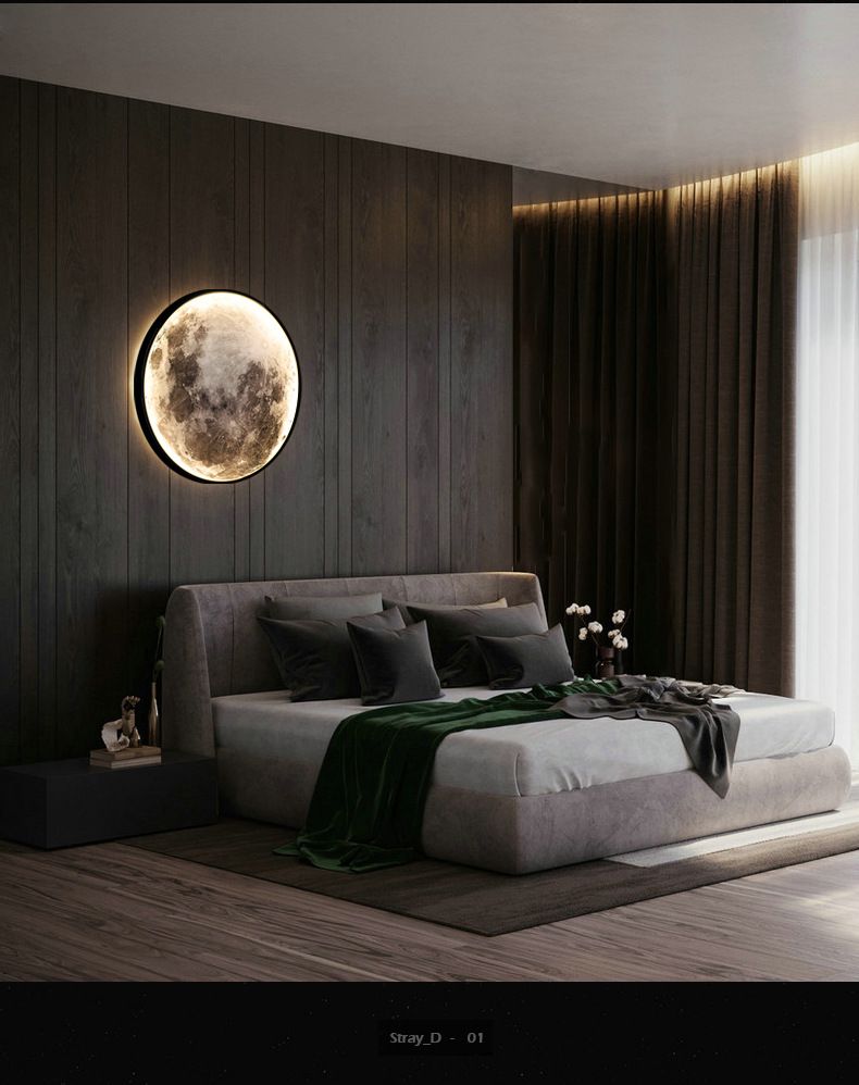 Dark bedroom with moon-shaped wall light, bed with gray linens, green throw, and dark wood paneling.