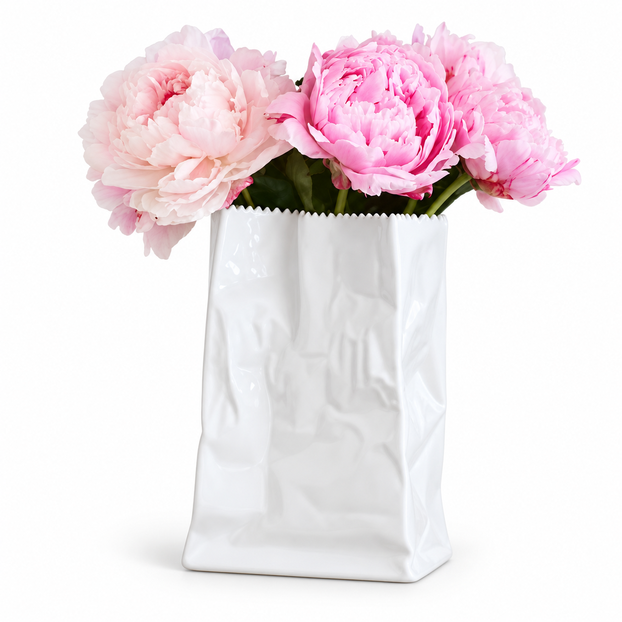 White sculptural vase styled with pink peonies