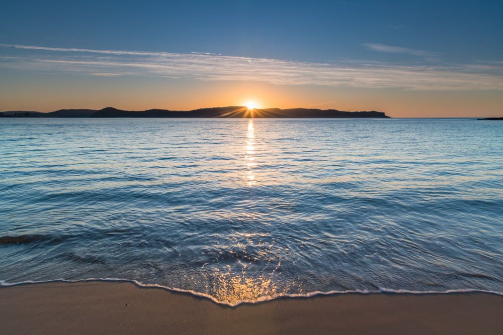 A Beach With a Sunset in the Background — CTE Systems In Old Bar, NSW