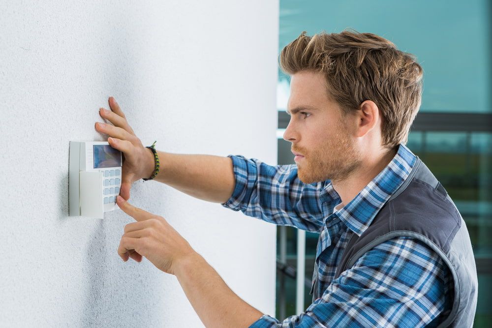 A Man Repairing an Intercom — CTE Systems In Gloucester, NSW