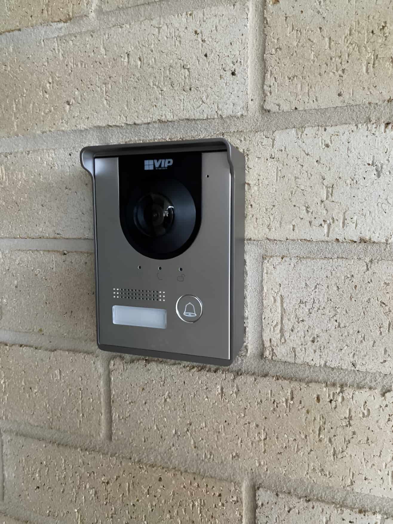 A Video Doorbell Mounted on a Textured Brick Wall — CTE Systems In Tuncurry, NSW