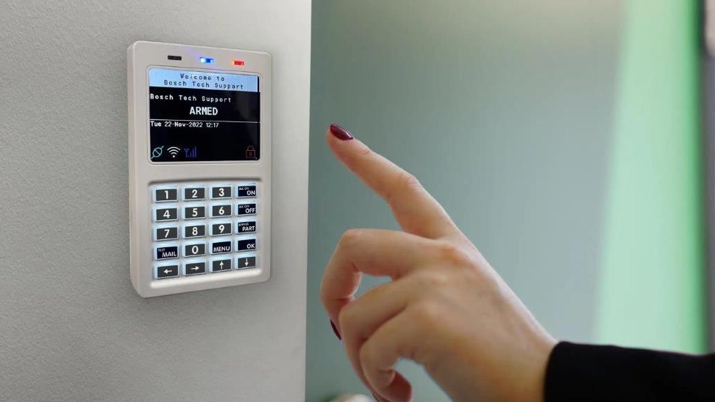 A Person is Pressing a Button on an Alarm Security System — CTE Systems In Tuncurry, NSW