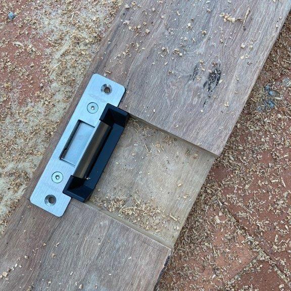 A Wooden Plank Featuring a Metal Latch — CTE Systems In Tuncurry, NSW