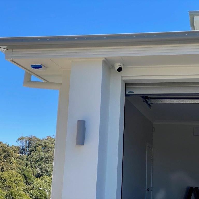 A Garage Door With a Mounted Security Camera — CTE Systems In Tuncurry, NSW