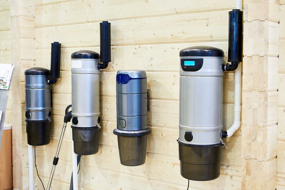 Three Vacuum Cleaners Are Hanging on a Wooden Wall — CTE Systems In Gloucester, NSW