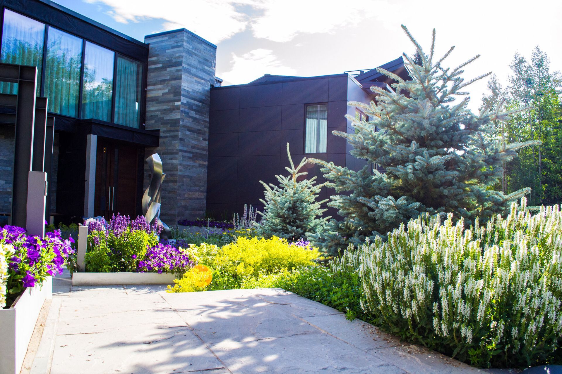 Large House Surrounded by Trees and Flowers — Berthoud, CO — Rocky Mountain  Environmental Construction