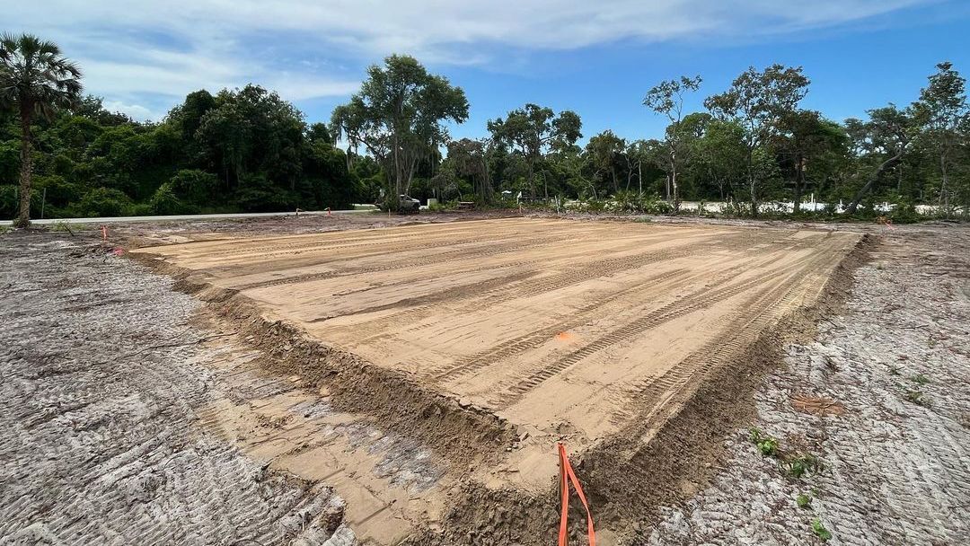 The freshly cleared and graded construction site was prepared for the concrete foundation with compa