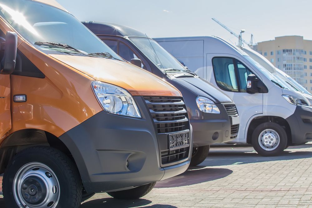 A Row Of Vans Parked Next To Each Other In A Parking Lot — Airlie Beach Exhaust and Mechanical In Airlie Beach, QLD