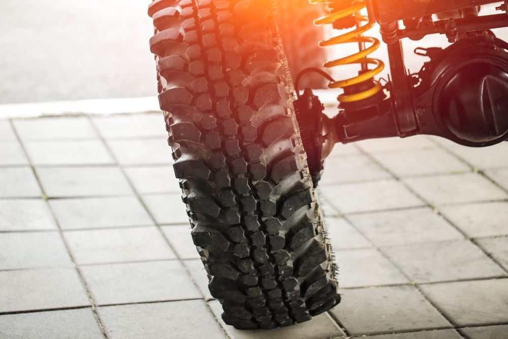 A Close Up Of A Tire And Shock Absorber On A Car — Airlie Beach Exhaust and Mechanical In Bowen, QLD