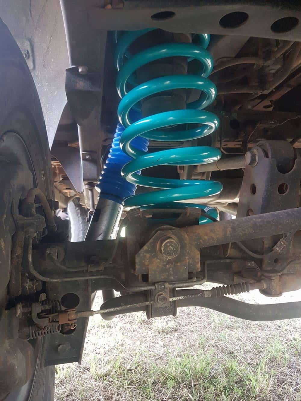A Close Up of a Shock Absorber on a Truck — Airlie Beach Exhaust and Mechanical In Airlie Beach, QLD