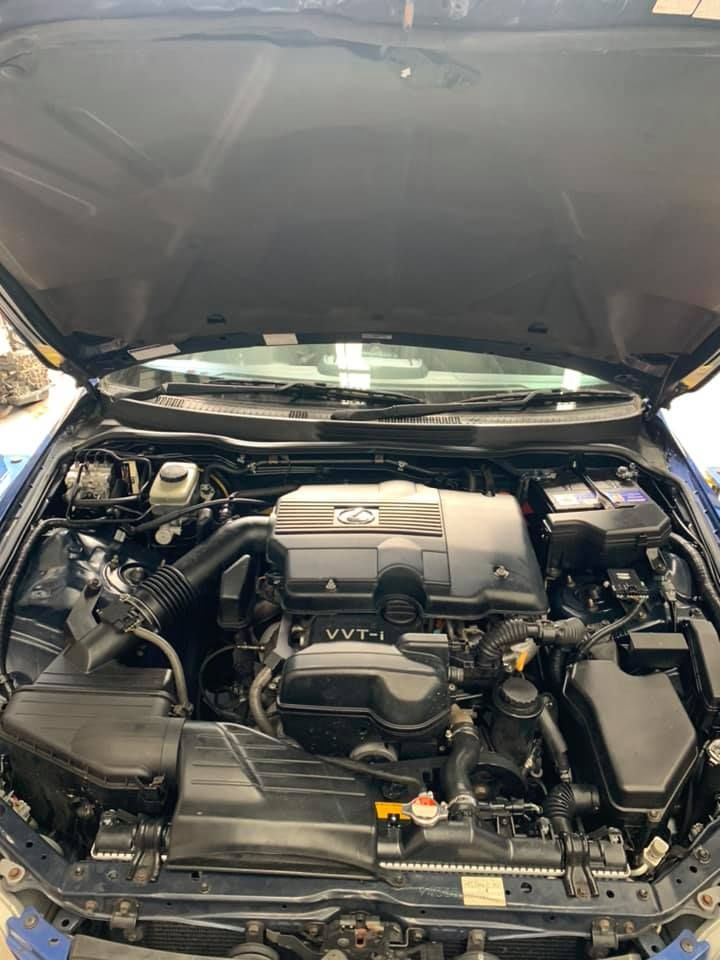 Engine Bay of a Dark Blue Car, Hood Open — D.A.G Automotive in Unanderra, NSW