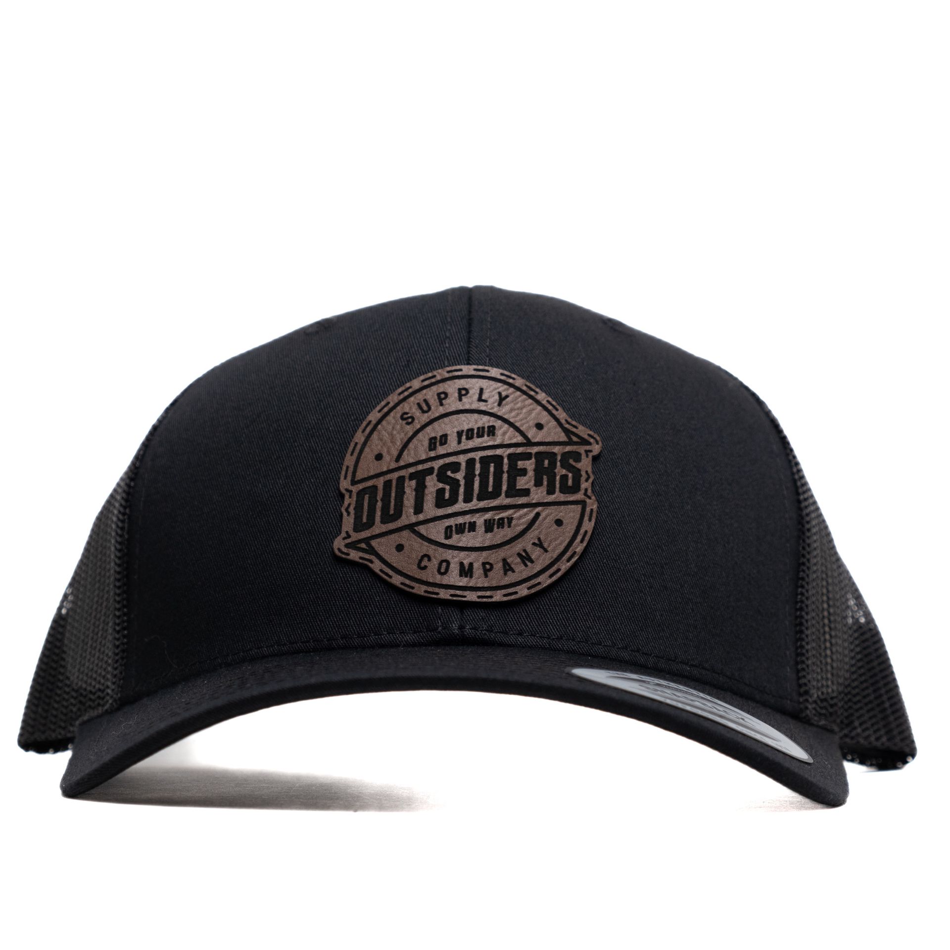A black trucker hat with a leather patch that says outsiders company.