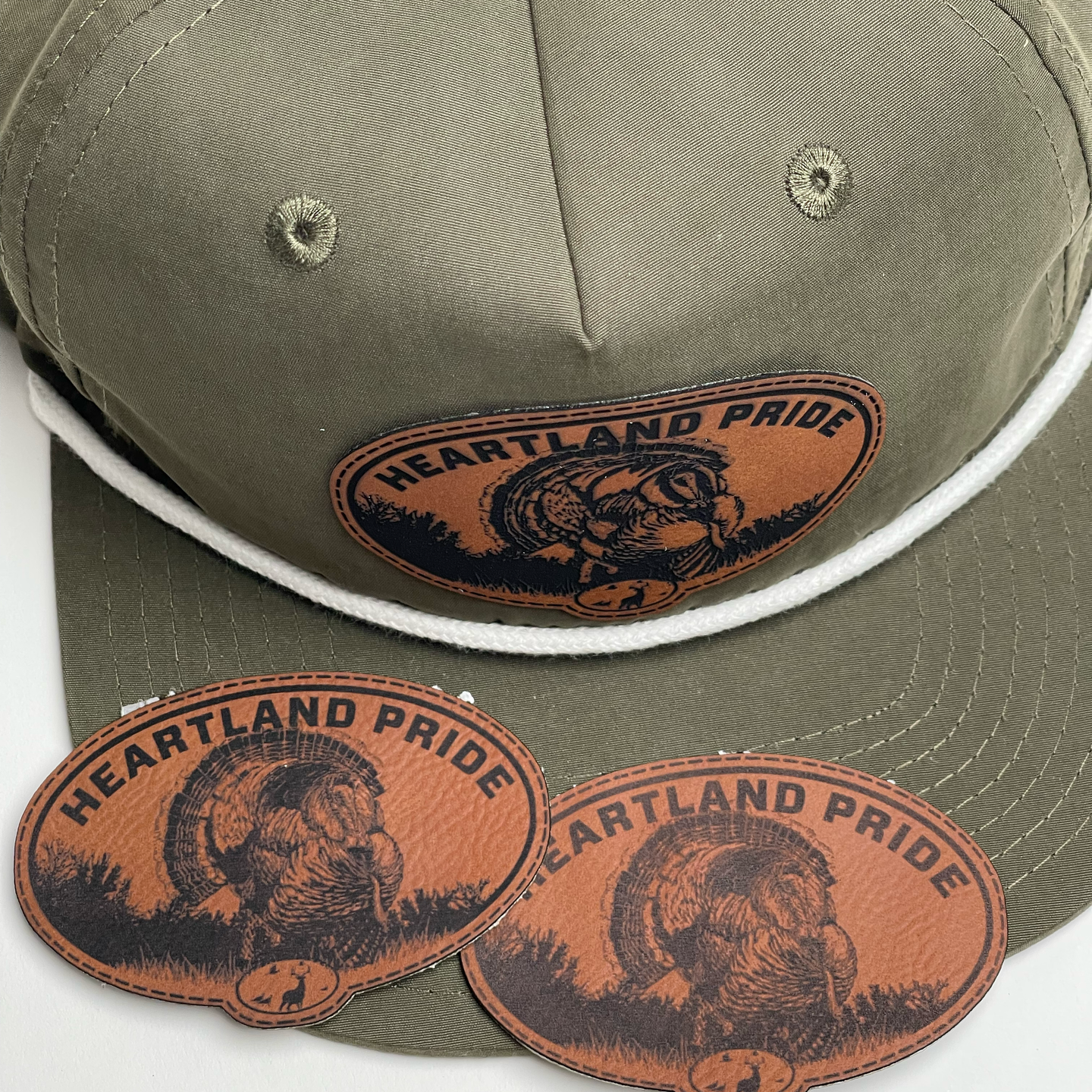 A hat with a leather patch that says heartland pride