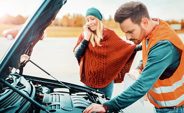 Mobile mechanic helping a stranded driver at roadside