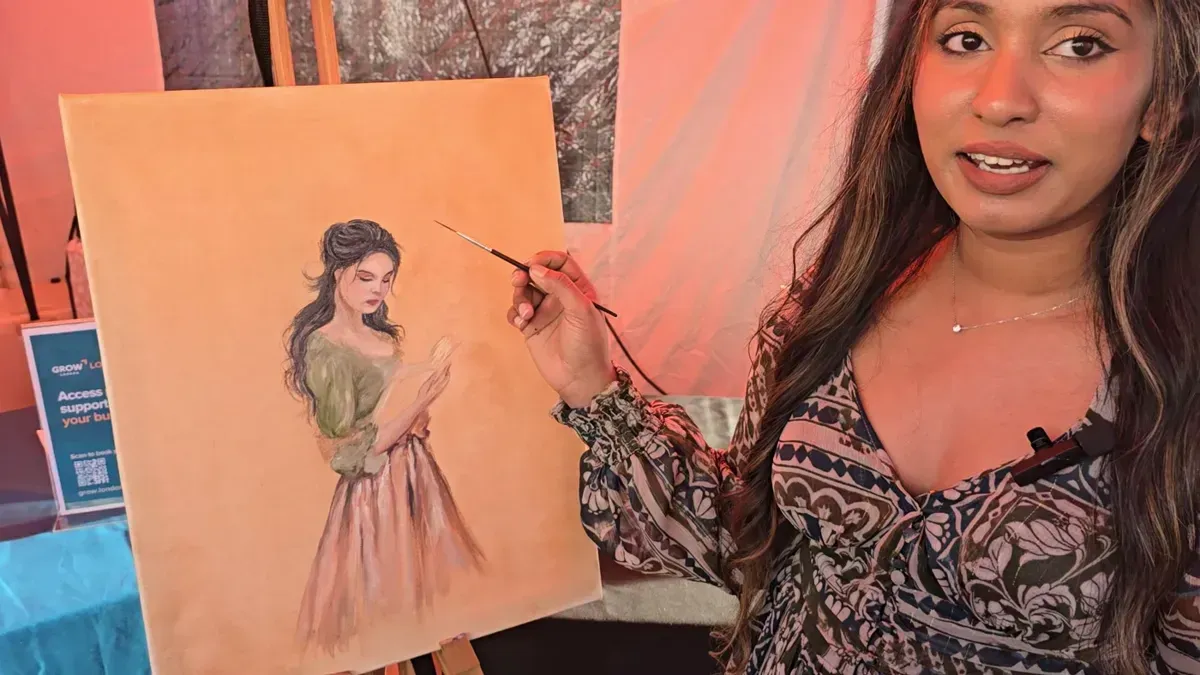 An artist painting a portrait in the Culture Zone