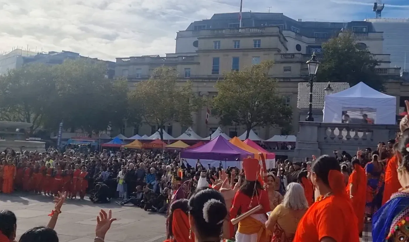 Crowds and dancers on Trafalgar Square in the afternoon sun