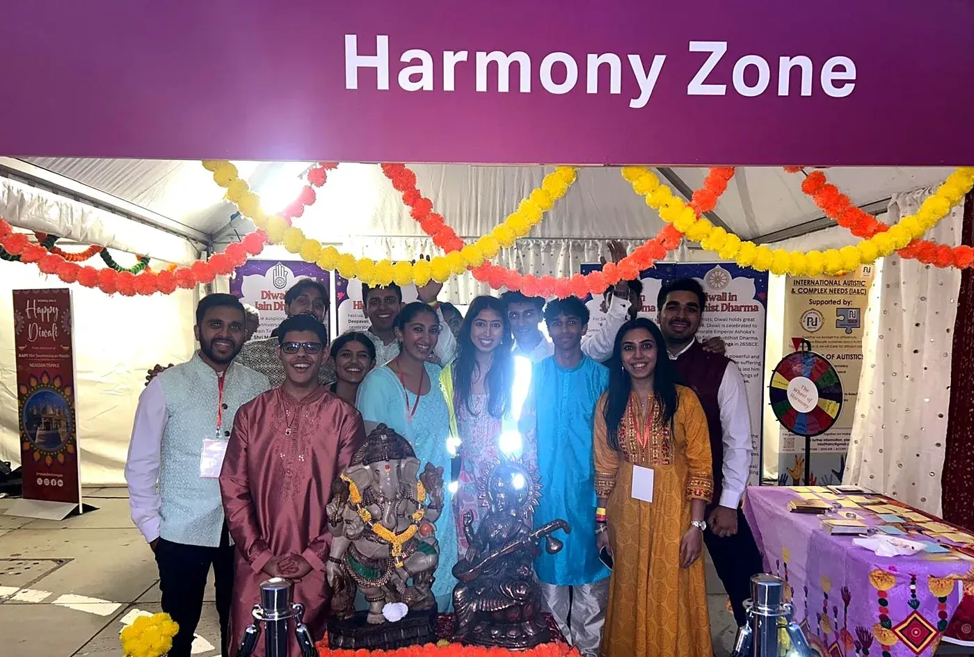 Volunteers in the Harmony Zone tent with a Ganesh murti