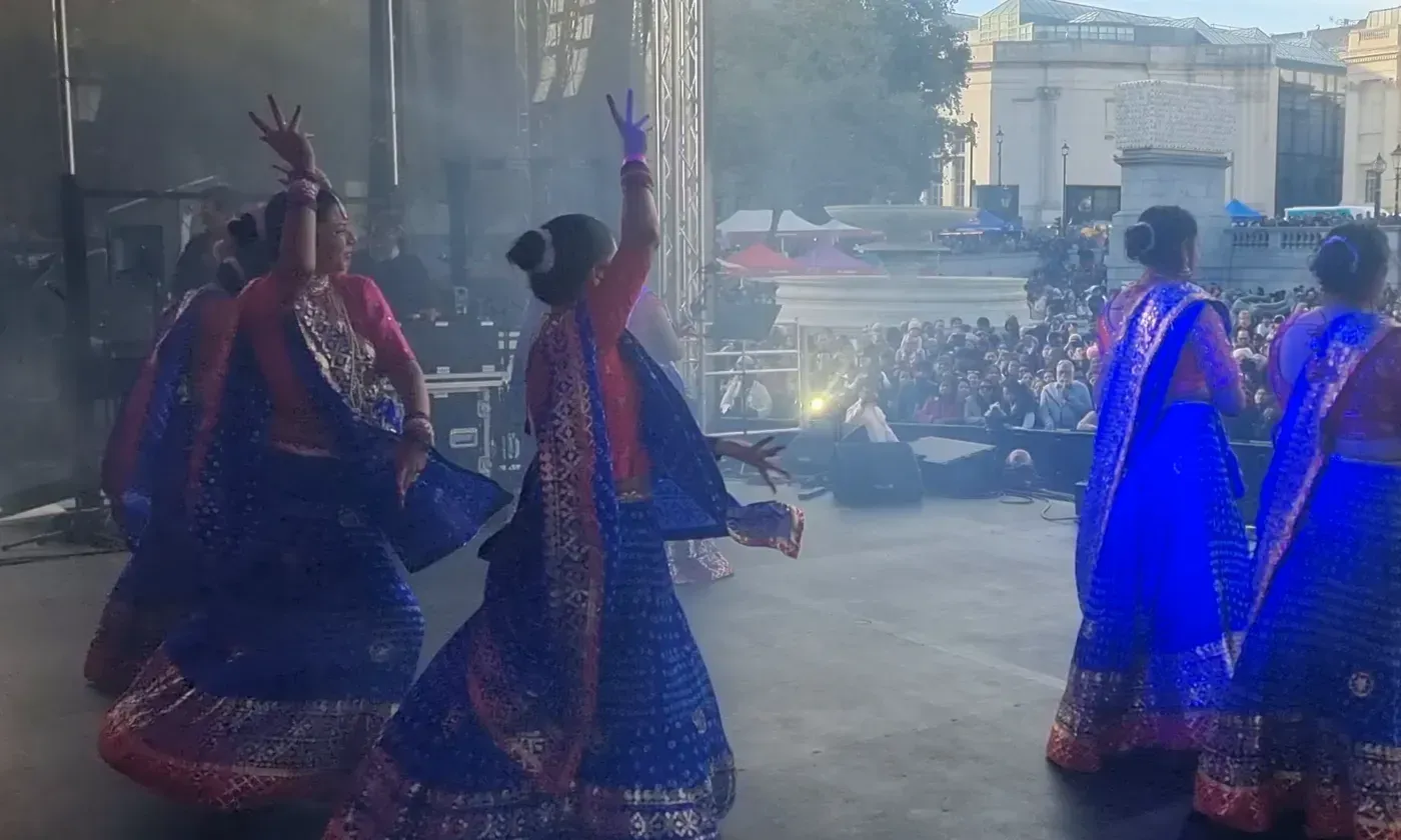 Dancers on the main stage with the crowd beyond