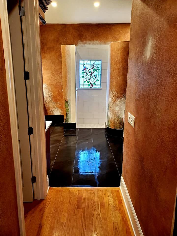 A hallway with a stained glass window in the doorway